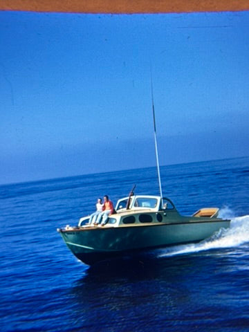Boat with people on a clear blue ocean