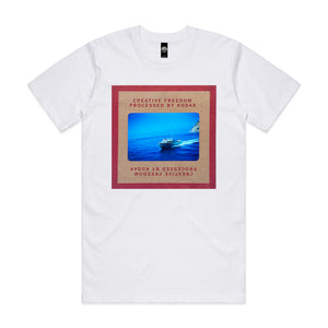 White t-shirt with a graphic design of a boat on water and text on a white background