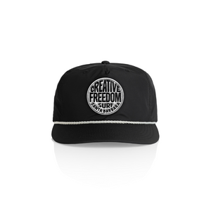 Black cap with 'Creative Freedom Surf Santa Barbara' logo on a white background