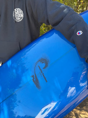 Blue kayak with a logo on a person wearing a dark jacket outdoors