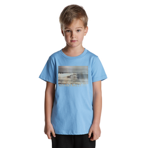 Child wearing a light blue t-shirt with a graphic design on a white background