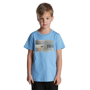 Child wearing a light blue t-shirt with a graphic design on a white background