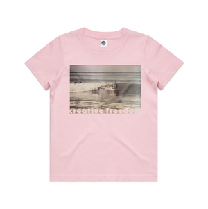 Pink t-shirt with a graphic of a boat on water and text 'freedom' on a white background