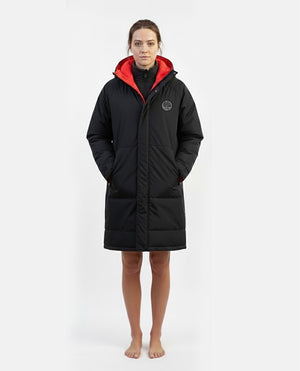 Female wearing a black coat with red interior on a white background