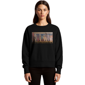 Person wearing a black sweatshirt with a graphic design on a white background